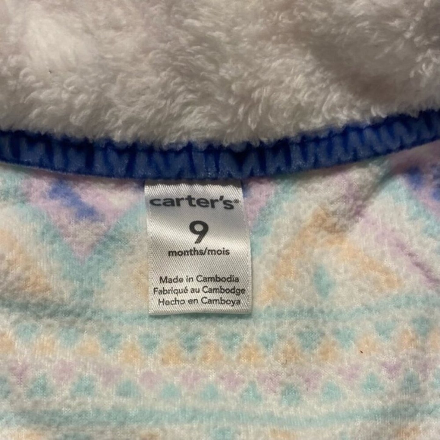 Carter's size label on a baby blanket with pastel patterns