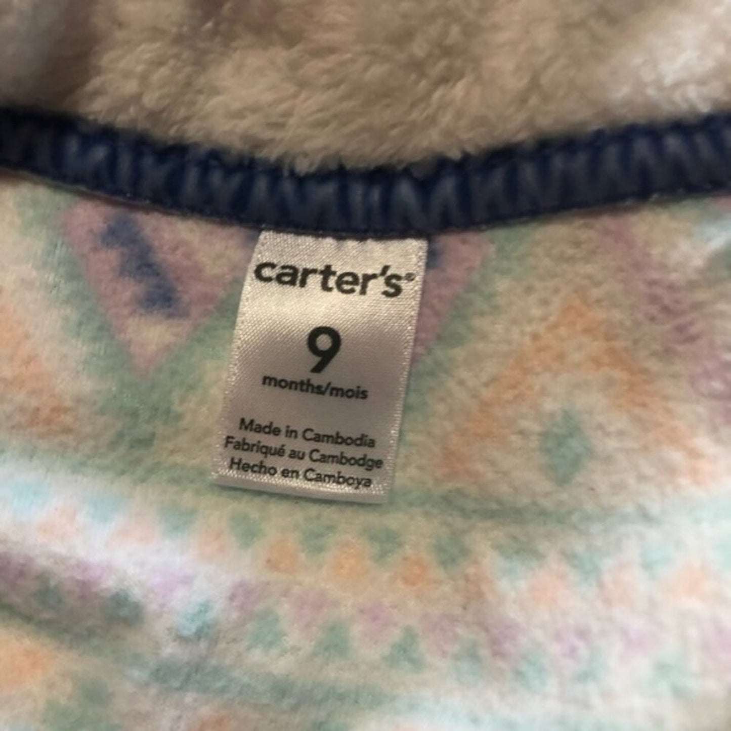 Carter's size label on a baby blanket with a checkered pattern