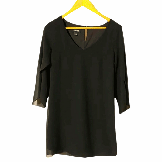 Black dress on a yellow hanger against a gray background