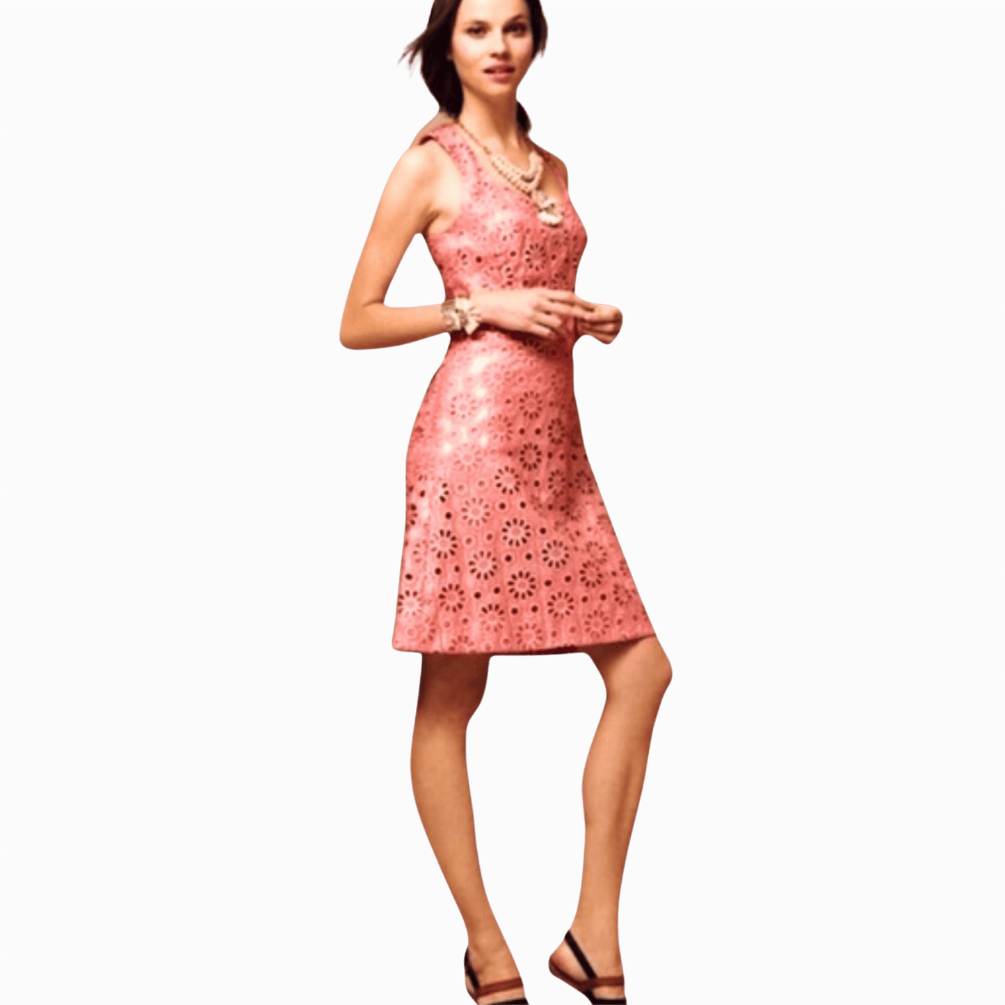 Woman wearing a pink dress with floral cut-out pattern on a brown background