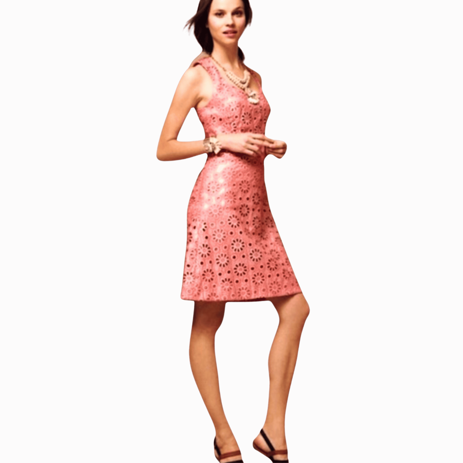Woman wearing a pink dress with floral cut-out pattern on a brown background