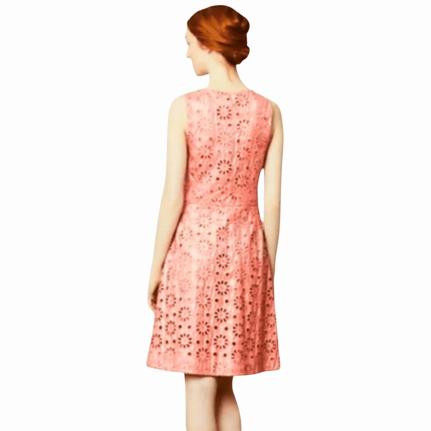 Woman wearing a pink floral dress on a gray background