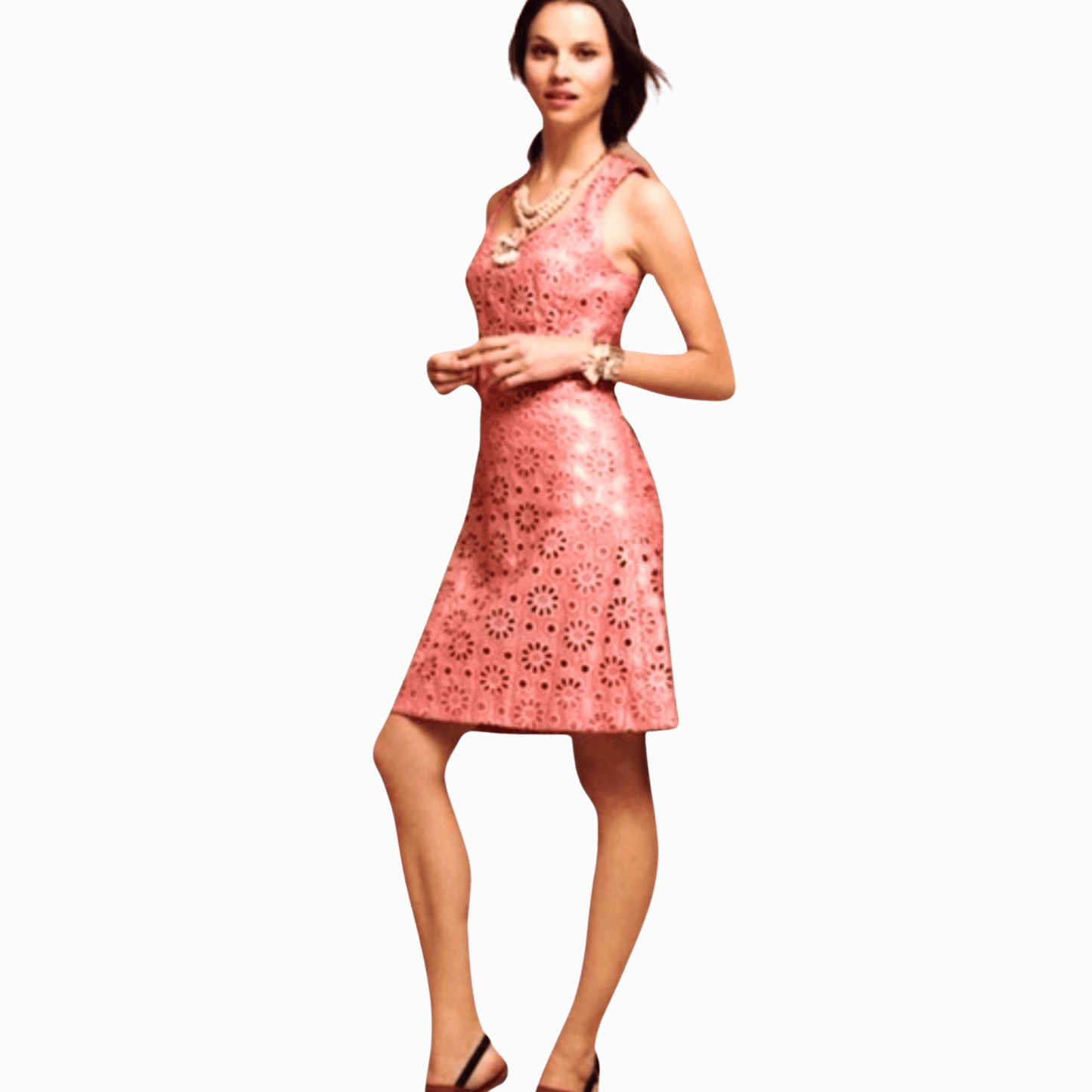 Woman wearing a pink dress with a floral pattern on a brown background