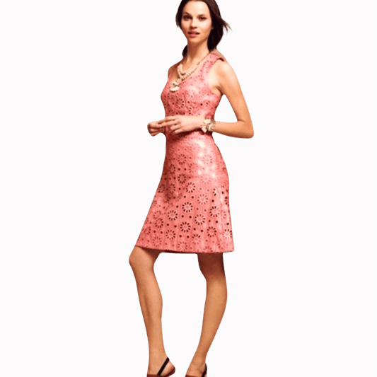 Woman wearing a pink dress with a floral pattern on a brown background