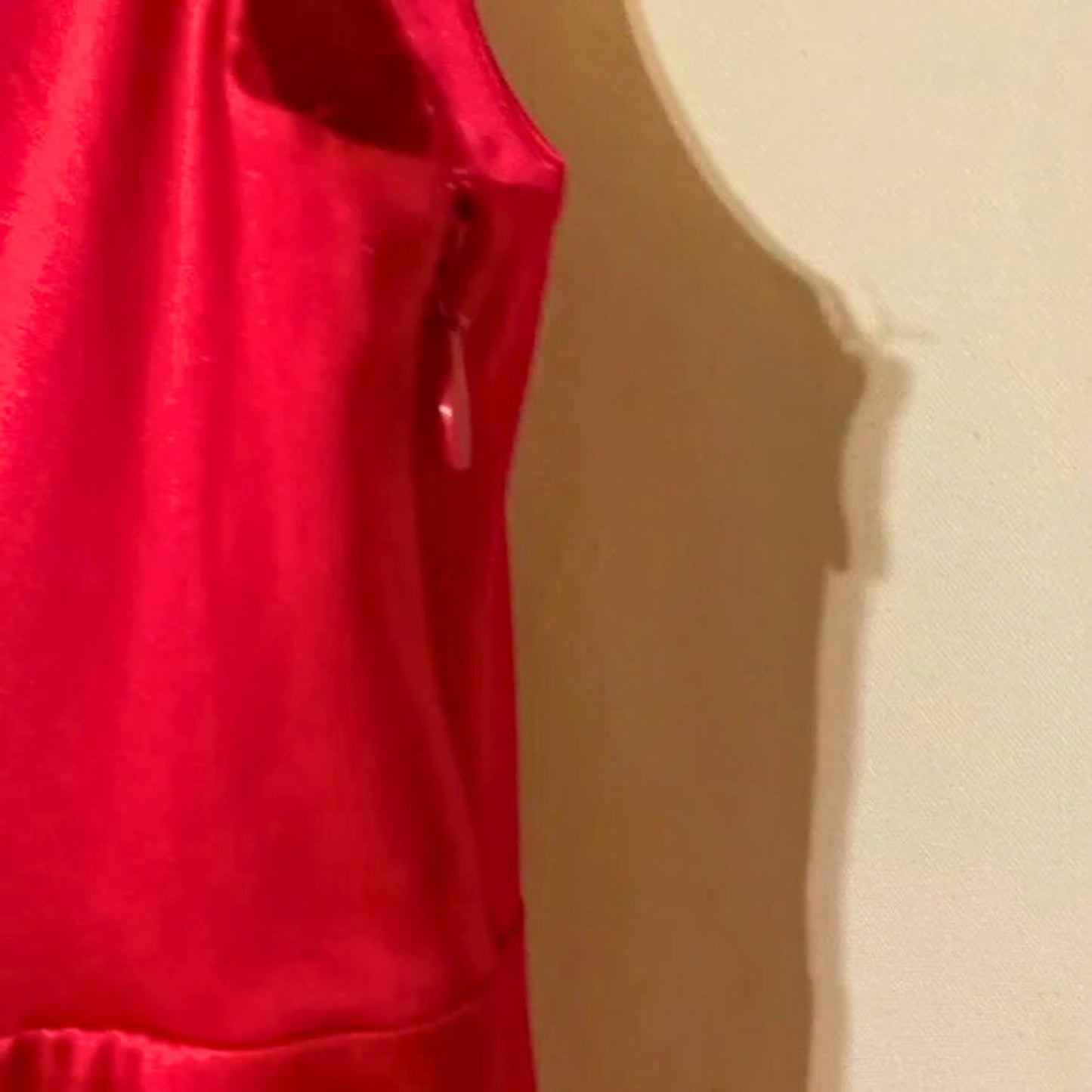 Red sleeveless top on a beige background