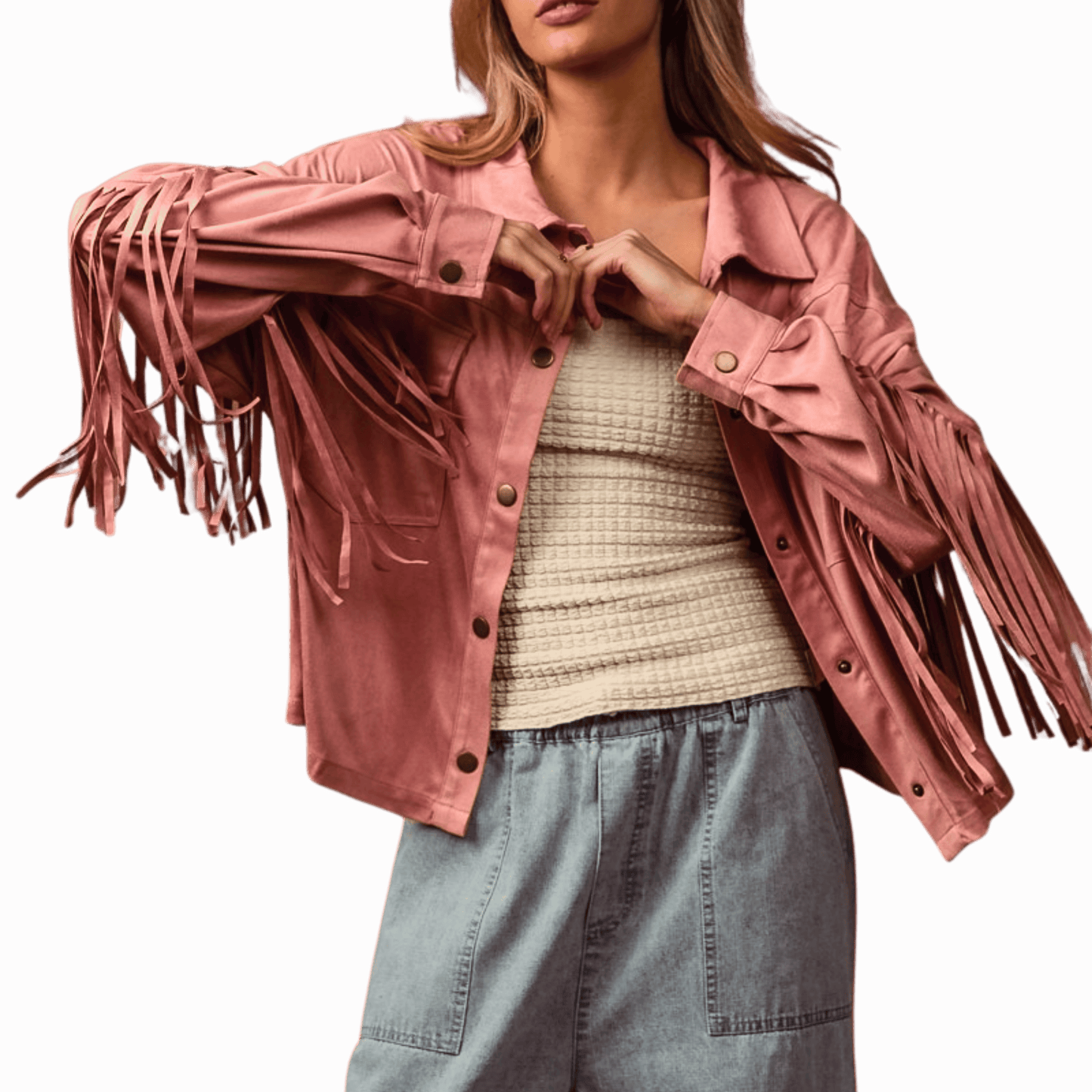 Woman wearing a pink fringed jacket over a beige sweater and blue jeans on a red background