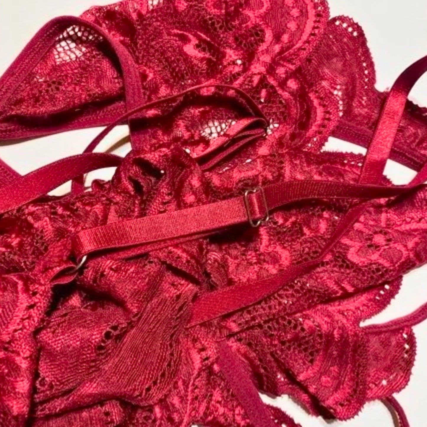 Red lace lingerie set on a white background