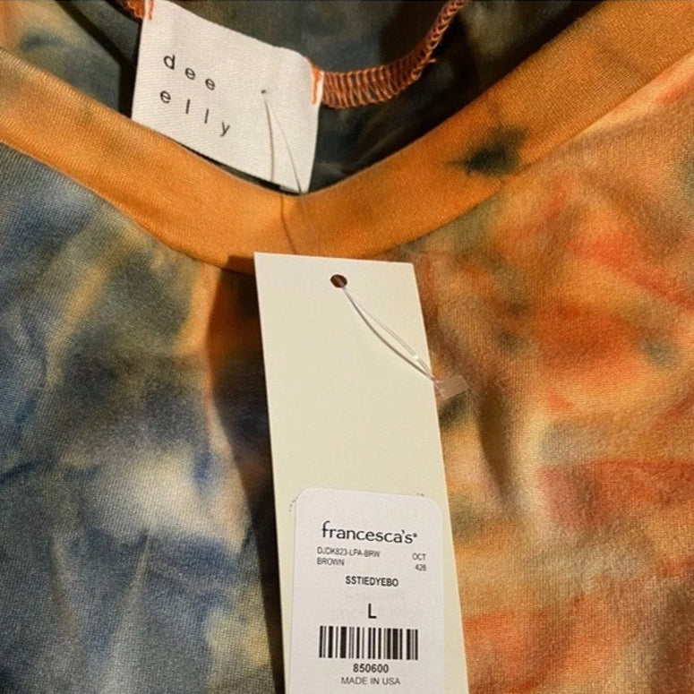 Tie-dye shirt with a Francesca's tag on a blurred background