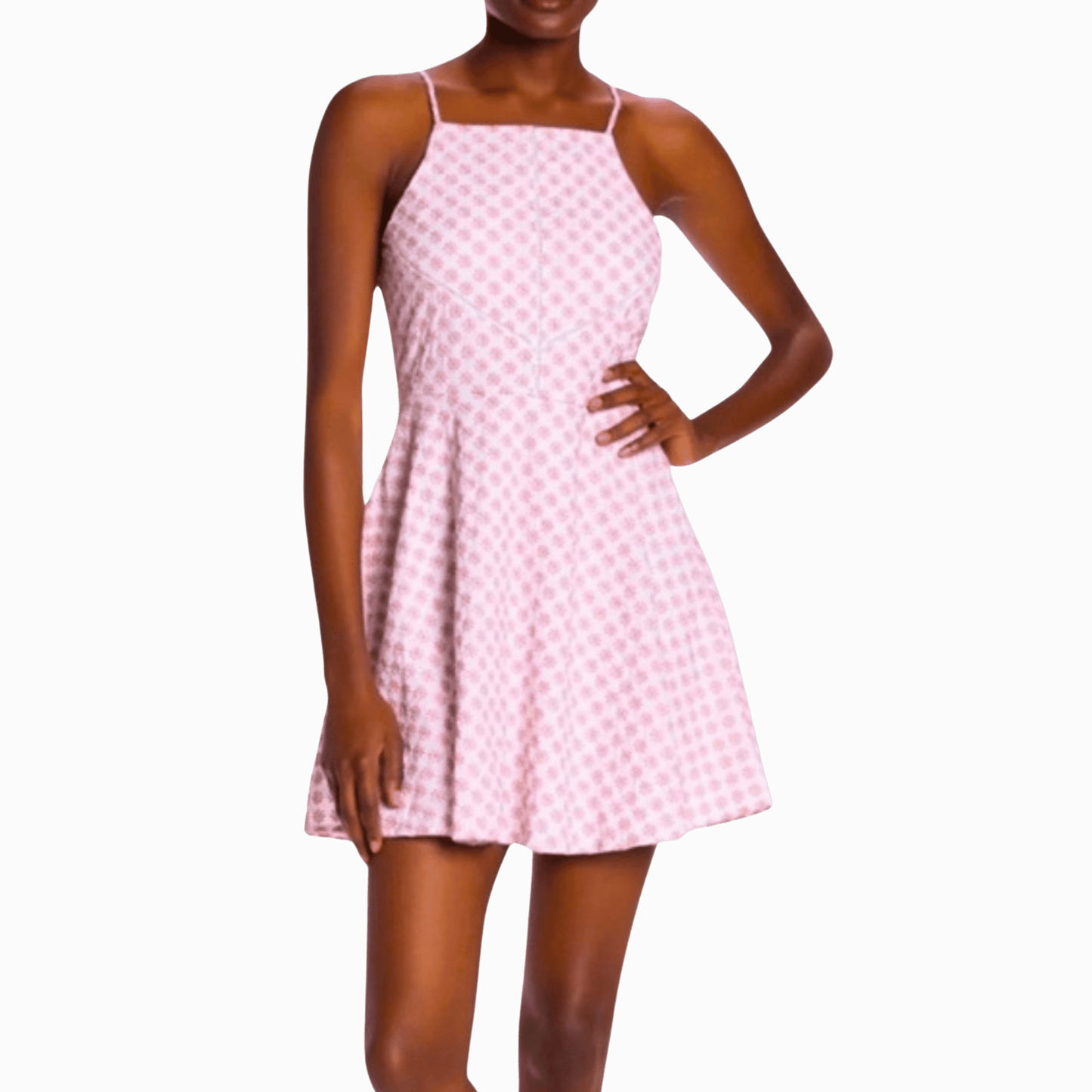 Woman wearing a pink checkered dress against a brown background
