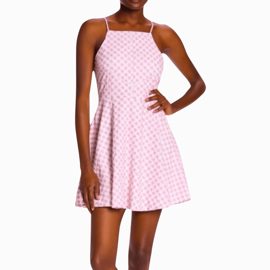 Woman wearing a pink checkered dress against a brown background