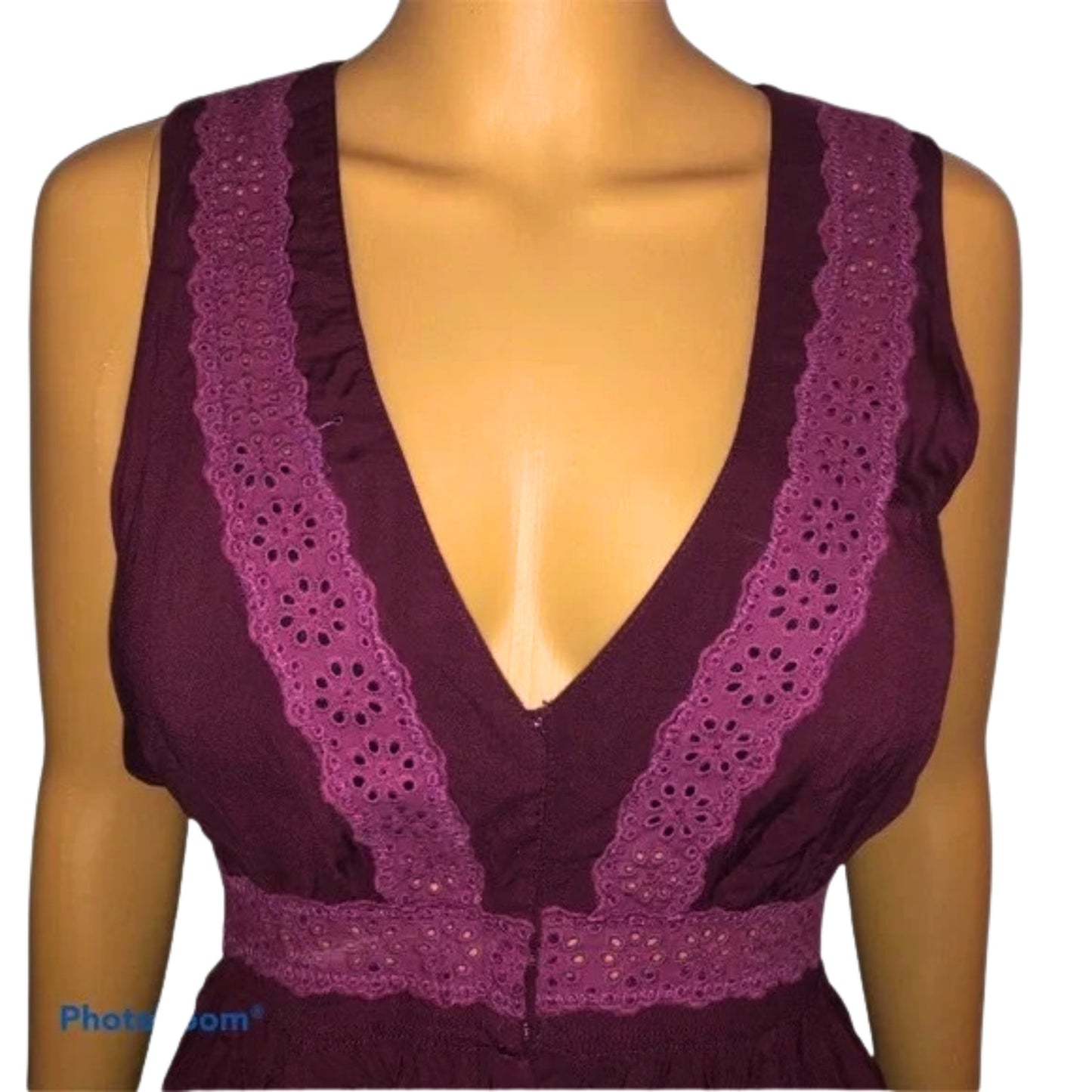 Mannequin wearing a deep purple sleeveless top with lace detailing on a white background