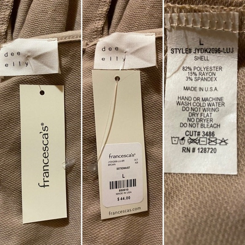 Close-up of clothing labels with 'francesca's' branding on a brown fabric background.
