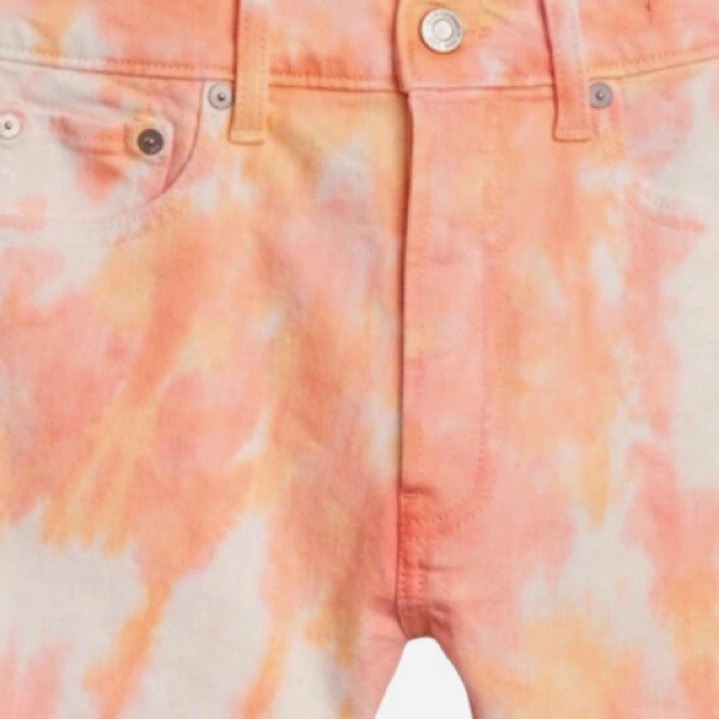 Close-up of a tie-dye shirt with orange and white patterns.