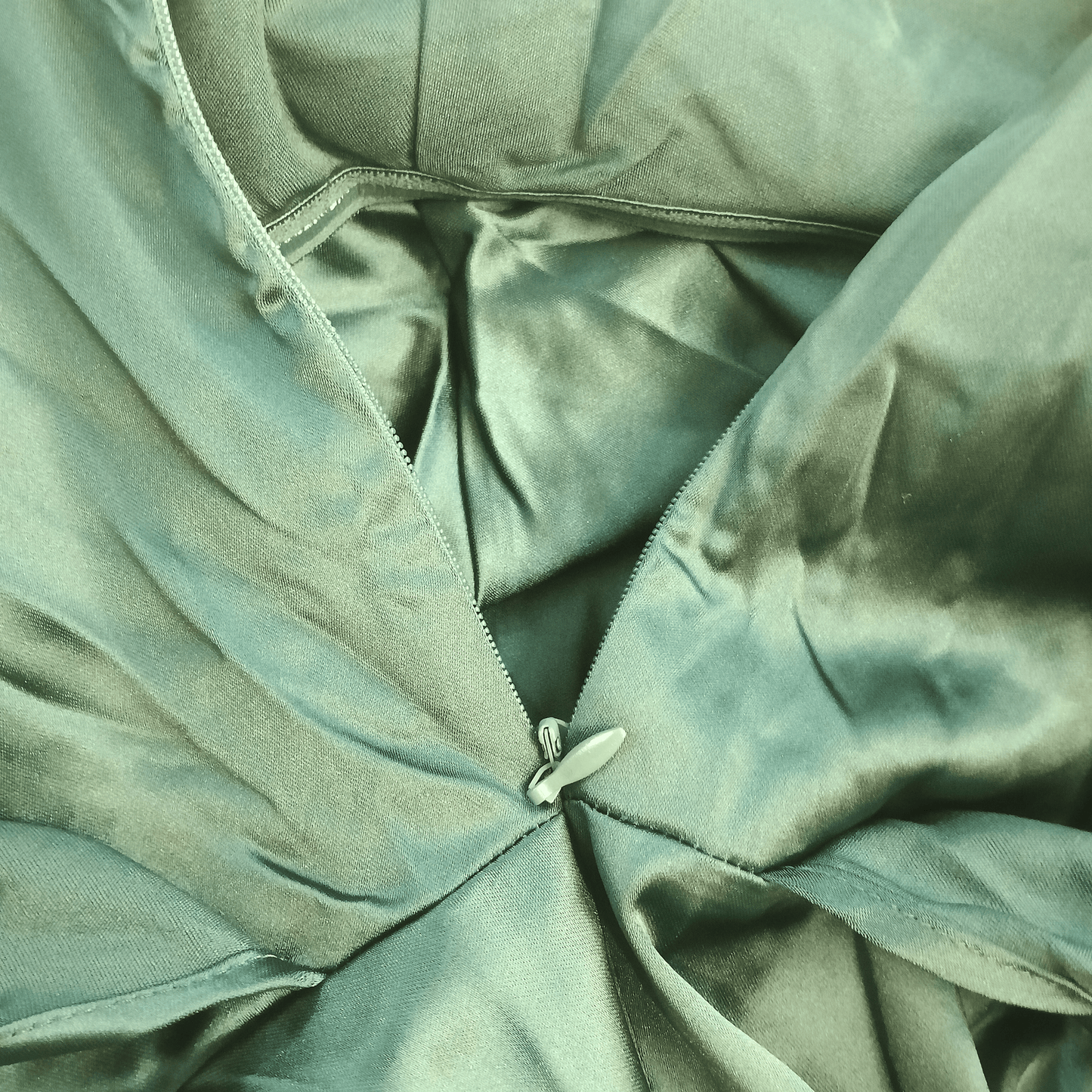 Close-up of a green fabric with a zipper