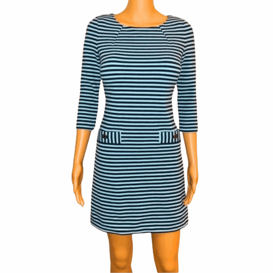Mannequin wearing a blue and white striped dress on a gray background