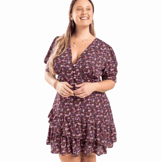 Woman wearing a floral dress against a red background