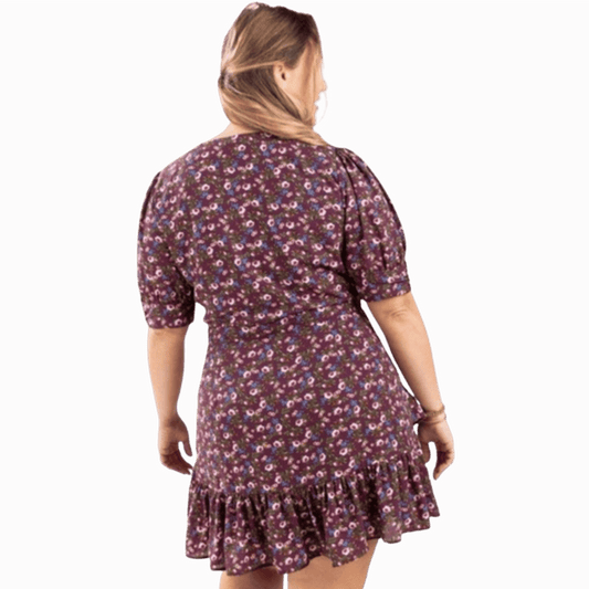 Woman wearing a floral dress on a brown background