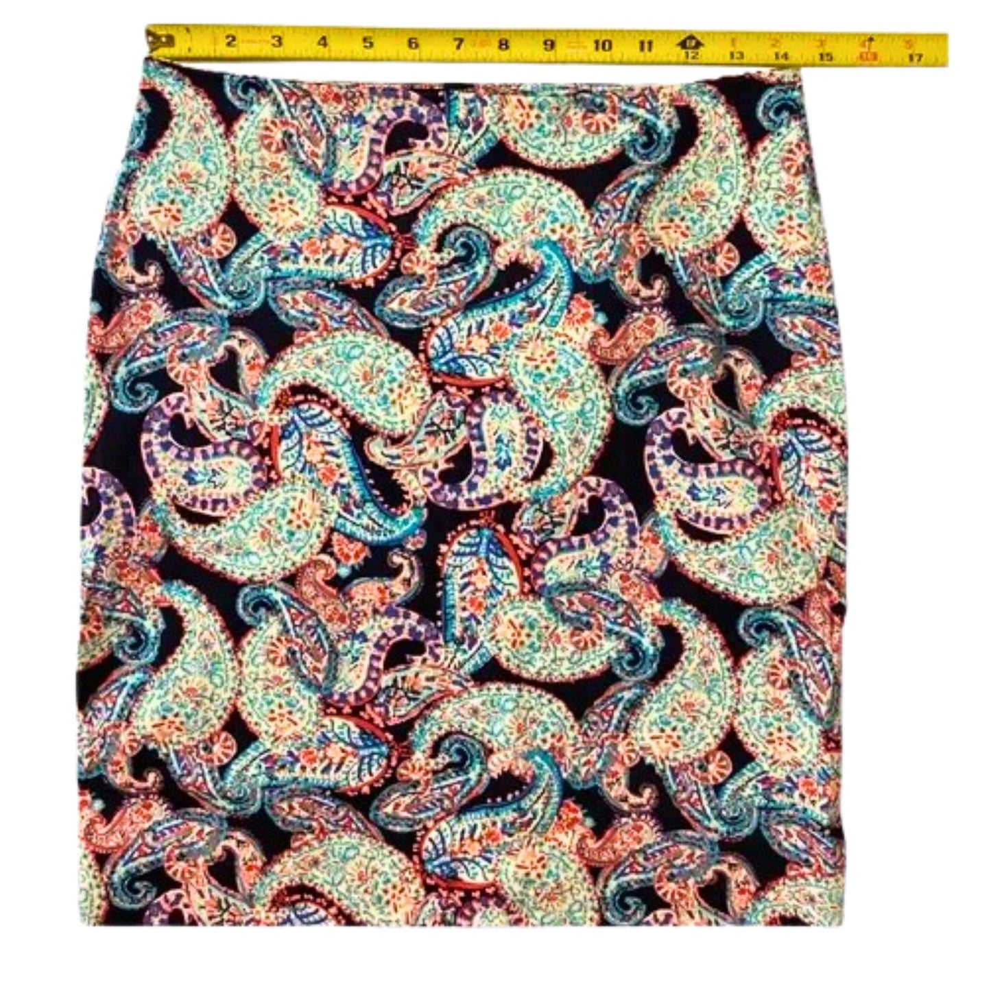 Colorful paisley patterned fabric with a measuring tape at the top.
