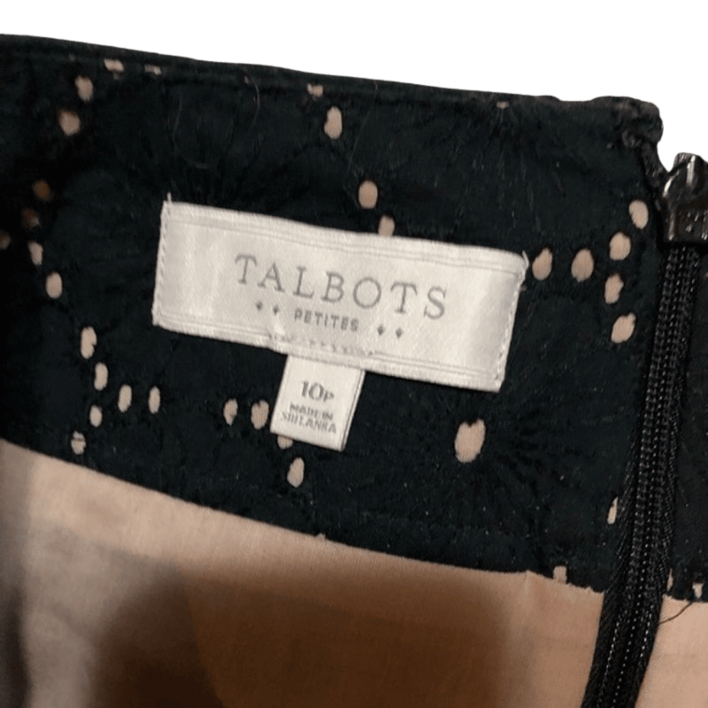 Close-up of a black polka dot garment with a Talbots label.