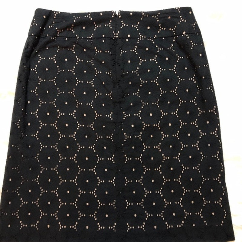 Black skirt with white floral pattern on a white background