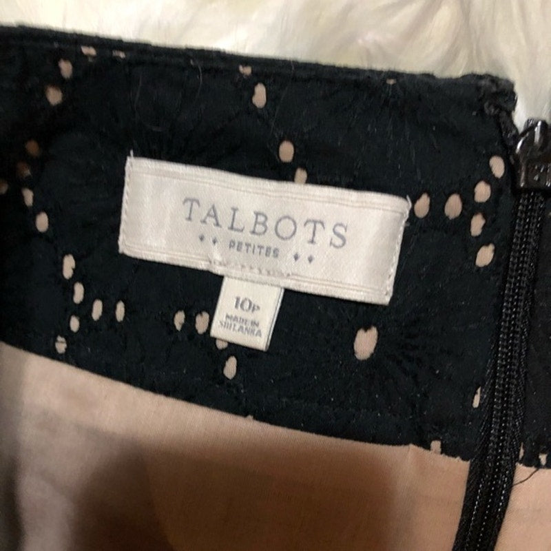 Black polka dot garment with Talbots label on a white background