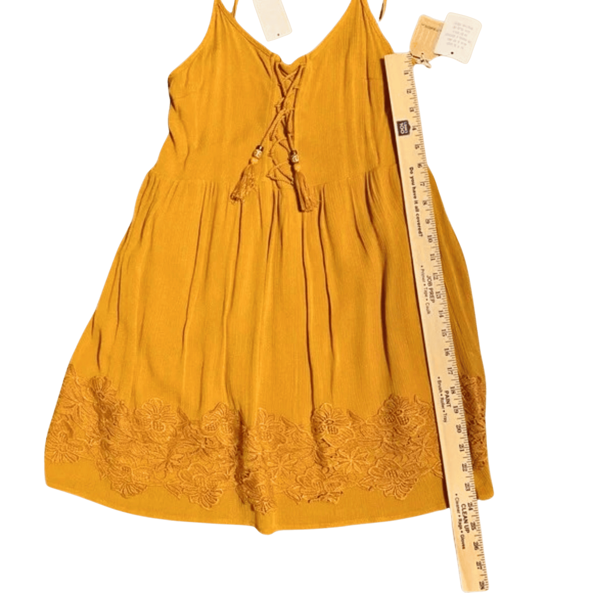 Yellow dress with floral embroidery and a ruler for size reference on a transparent background