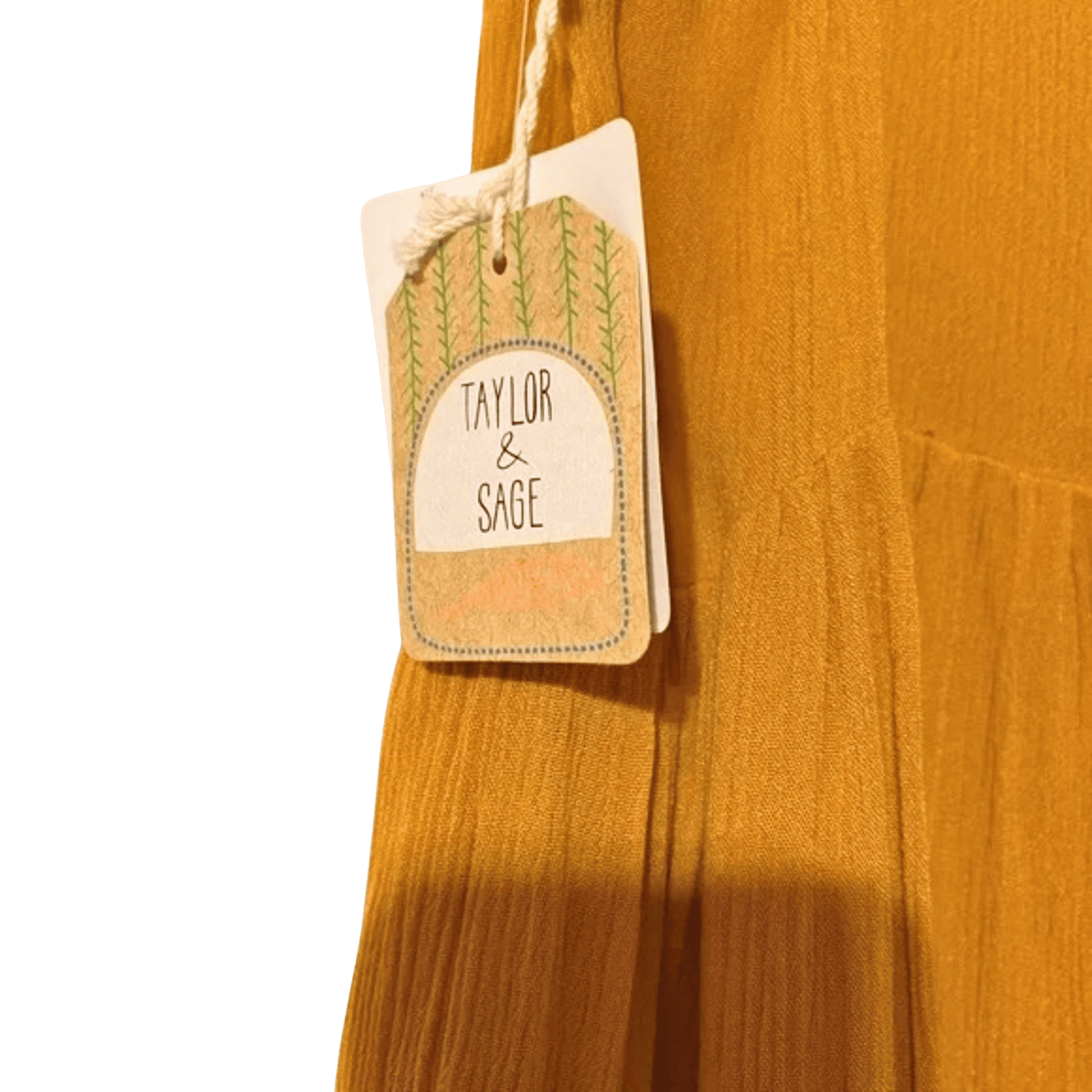 Mustard yellow fabric with a 'Taylor & Sage' tag on a green background