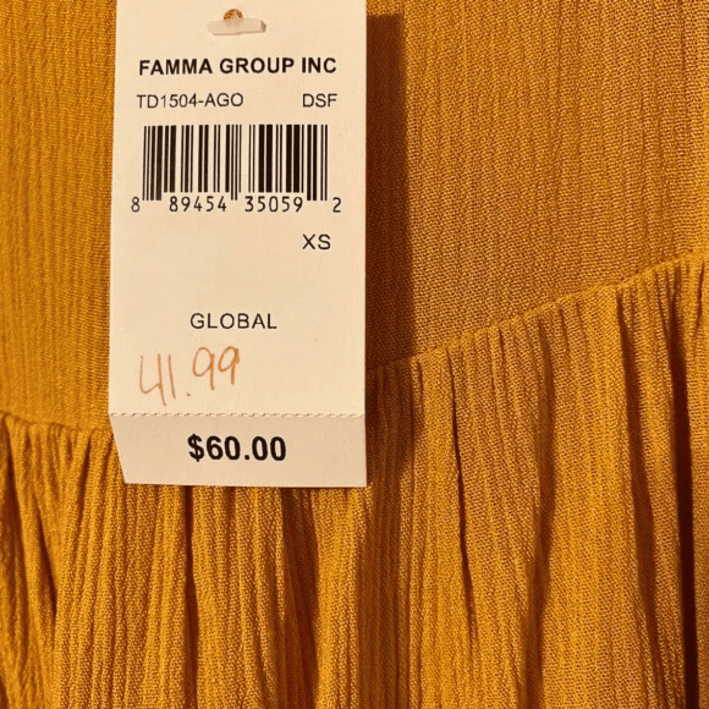 Yellow fabric with a price tag from Famma Group Inc.