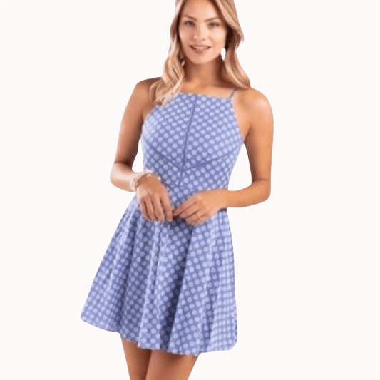 Woman wearing a blue polka dot dress on a brown background