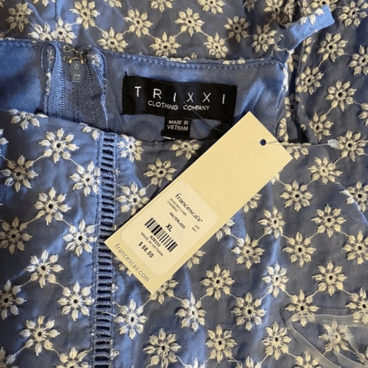 Blue floral-patterned fabric with a Trixxi clothing tag and Francesca's tag.