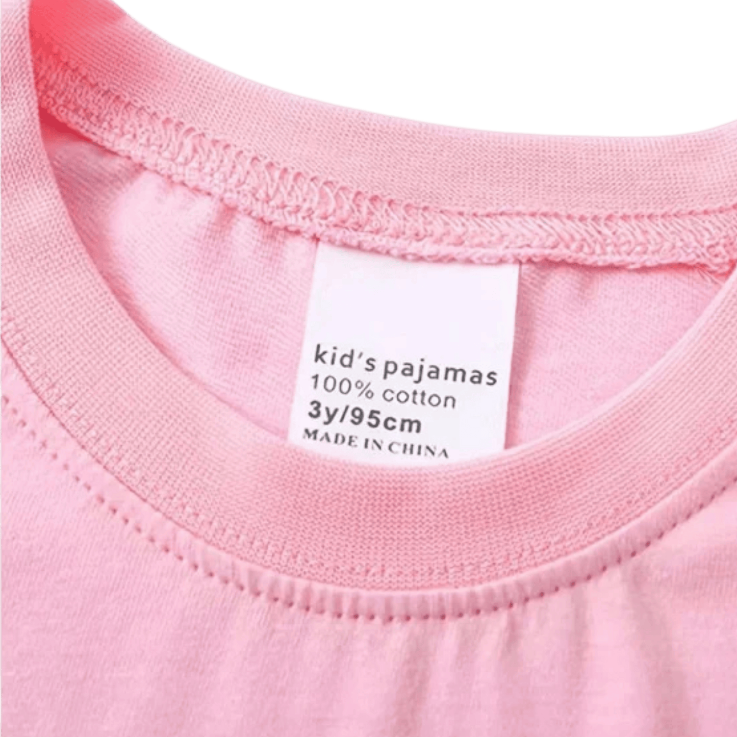 Close-up of a pink fabric label indicating 'kid's pajamas' with size information.