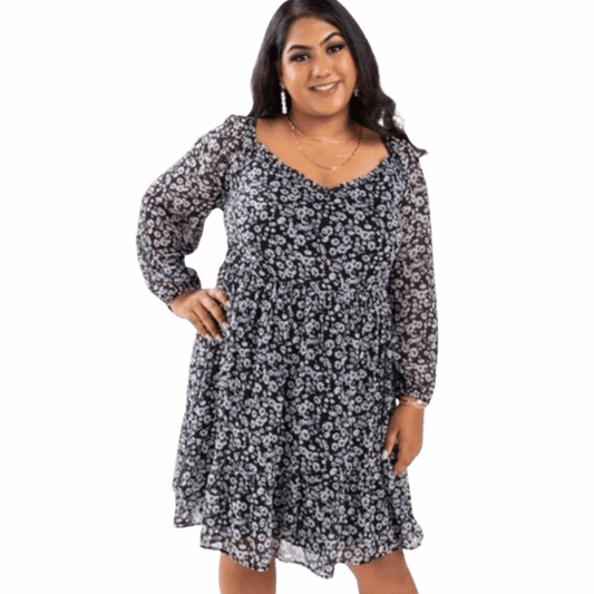 Woman wearing a floral dress on a gray background