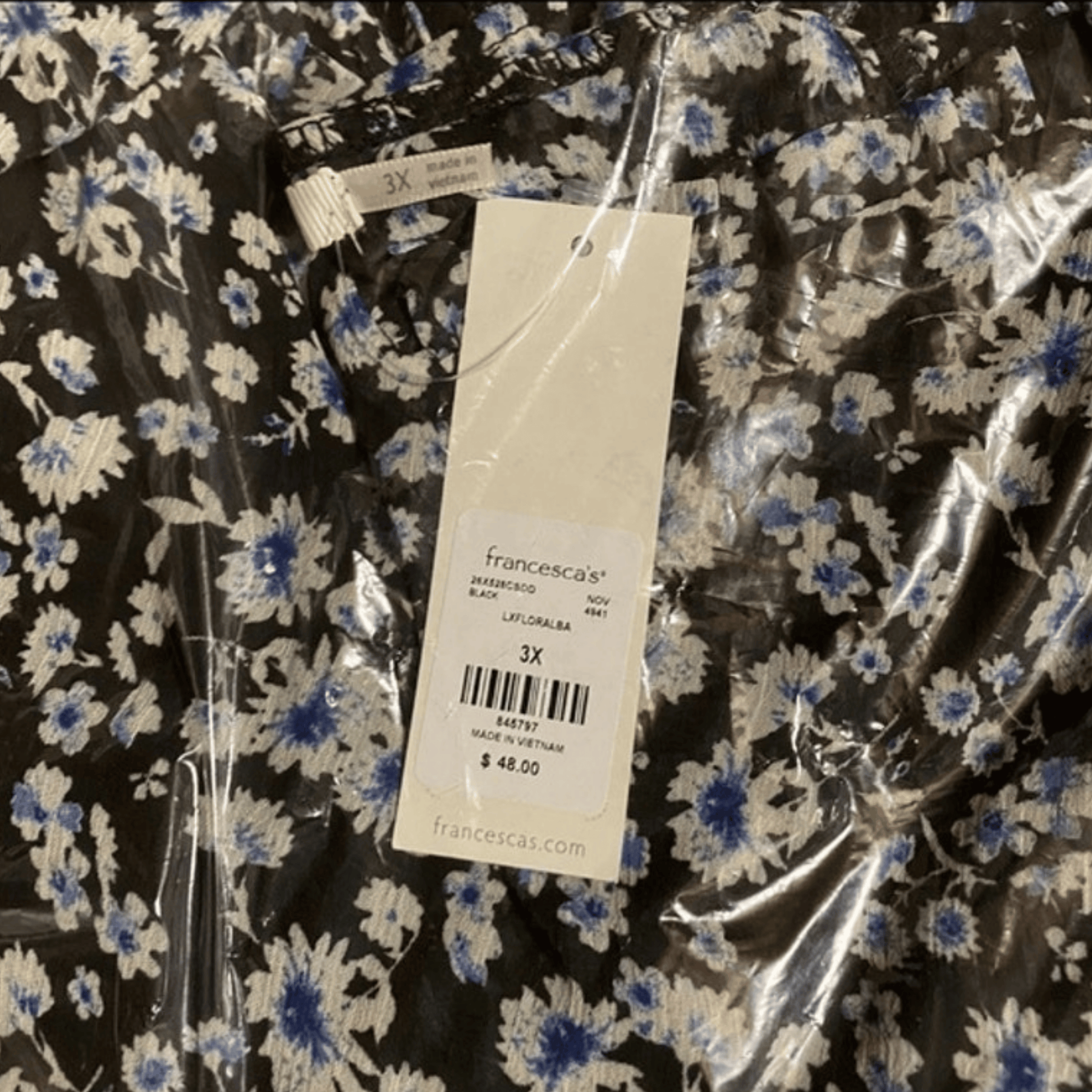 Floral dress with a Francesca's tag on a clear plastic bag