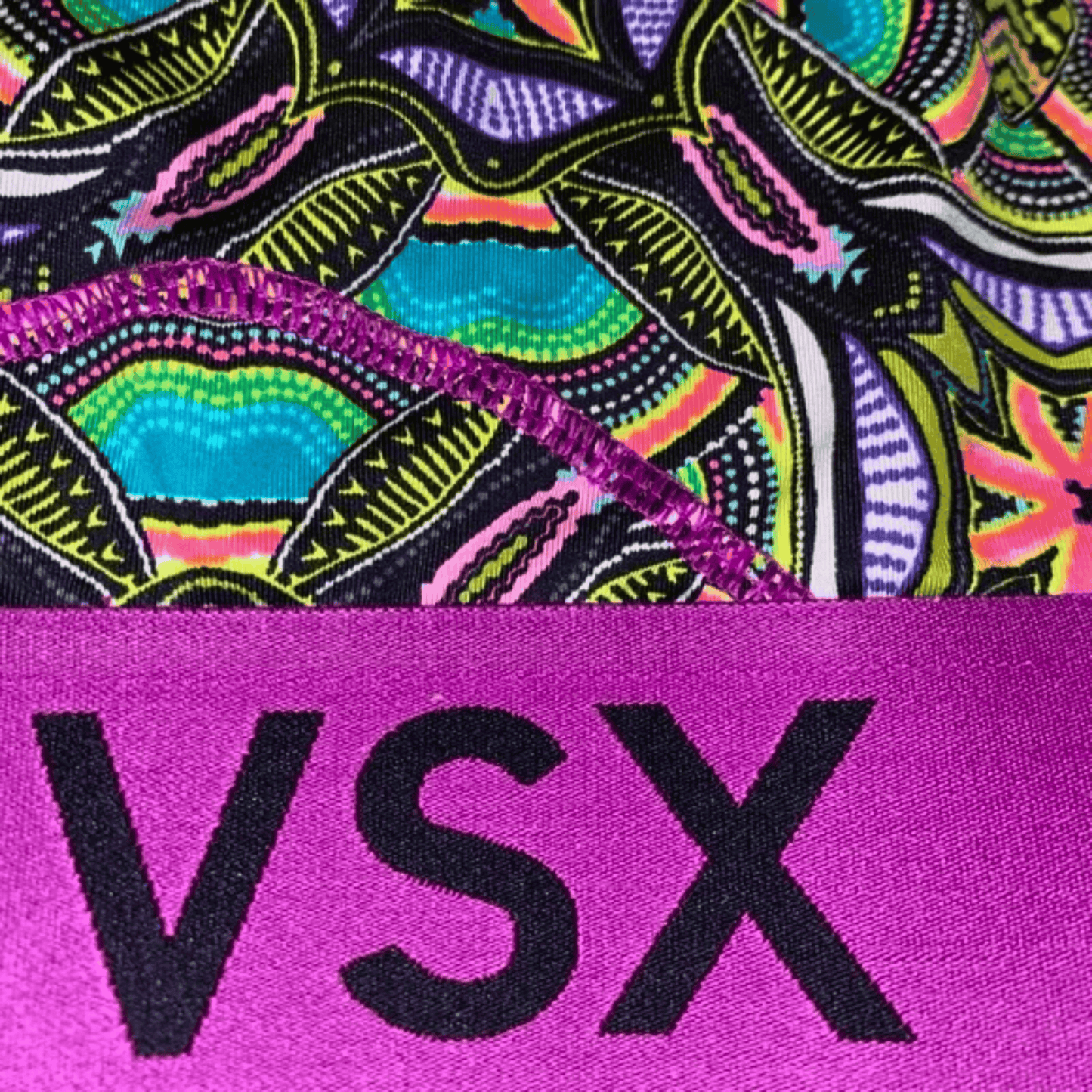 Colorful patterned fabric with 'VSX' logo on a purple background