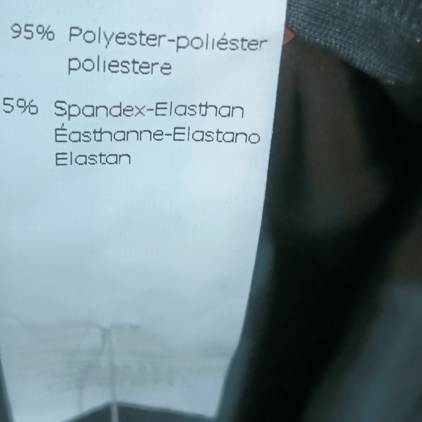 Text on a label detailing fabric composition with a blurred background