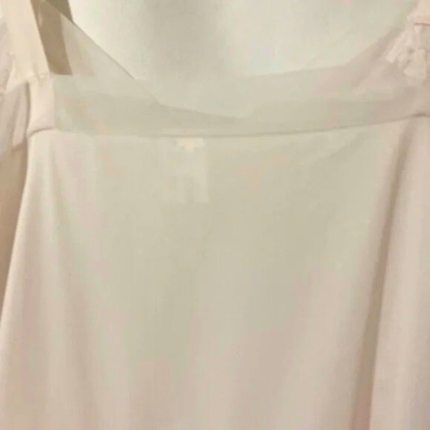 Close-up of a light-colored fabric with a subtle pattern