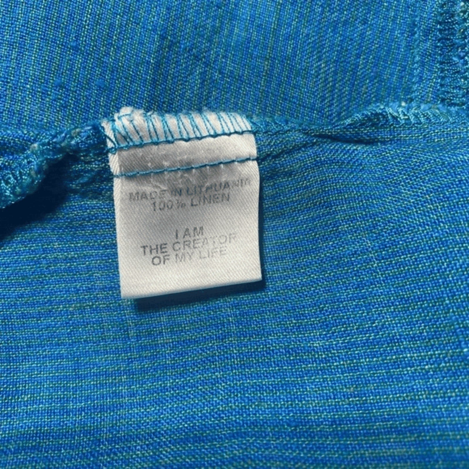 Textile label on blue fabric with motivational quote