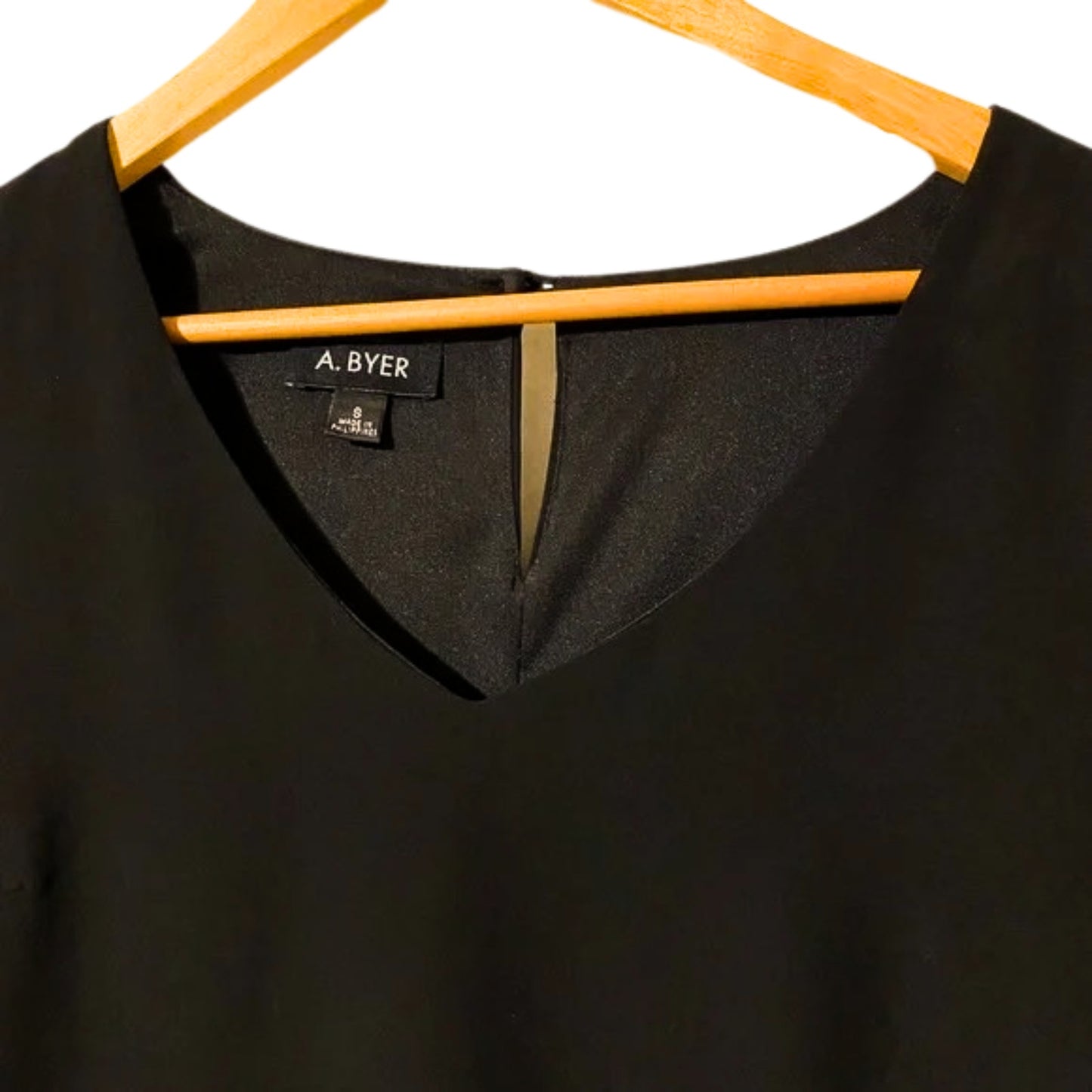Black shirt on a hanger with 'A. Byer' label