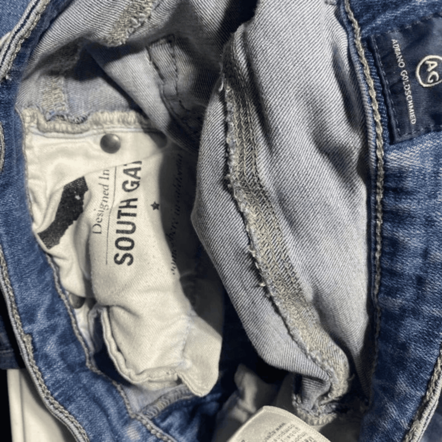 Close-up of denim fabric with 'South Bay' label inside a jacket