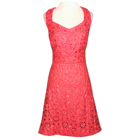 Red lace dress on a mannequin against a white background