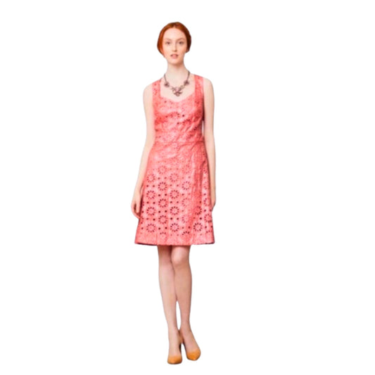 Woman wearing a pink floral dress on a white background