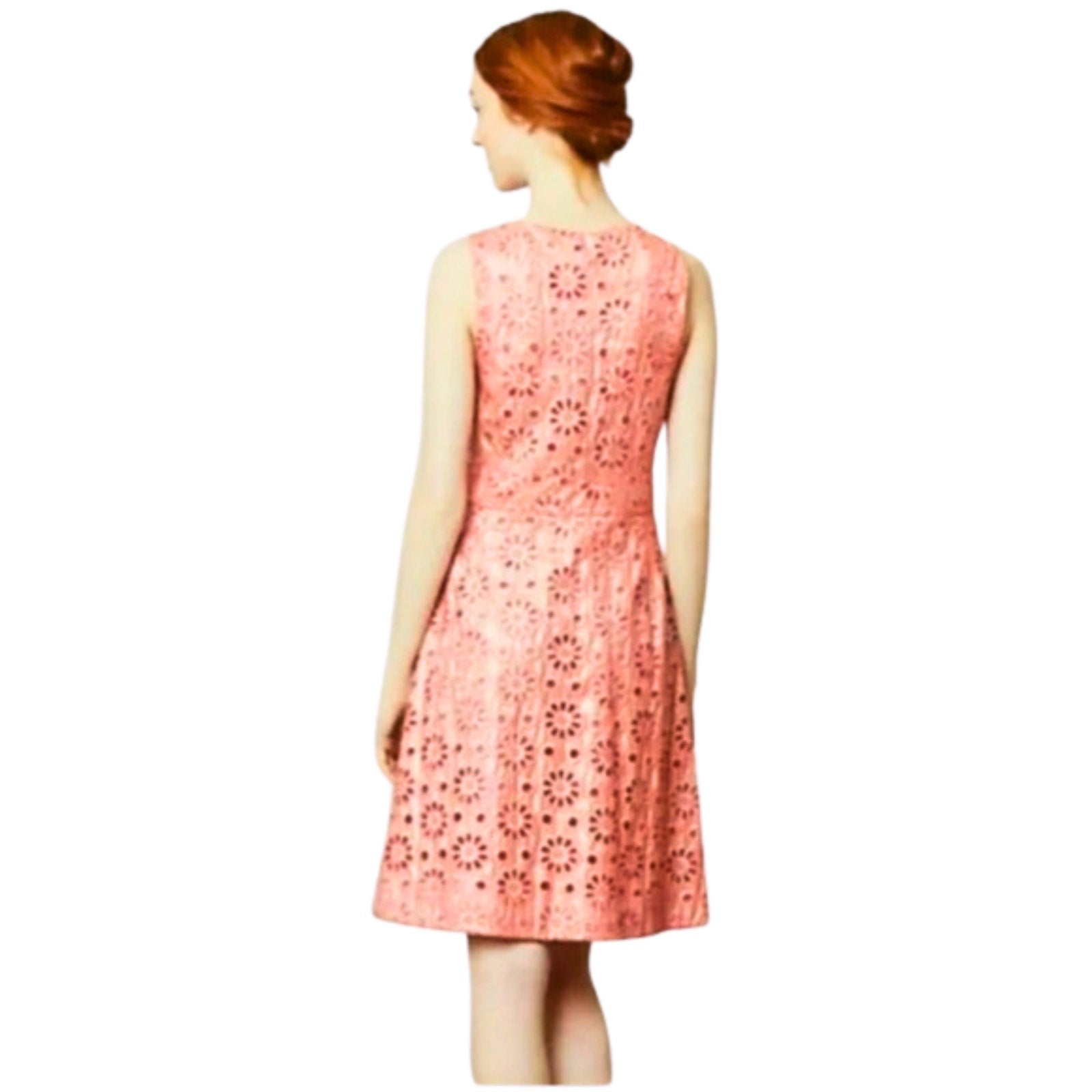 Woman wearing a pink floral dress on a white background