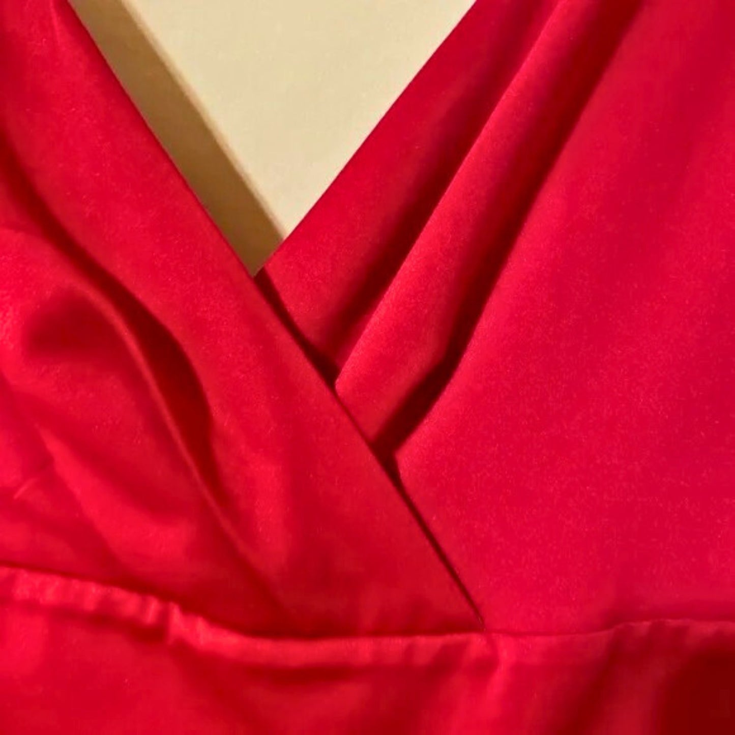 Close-up of red fabric with a yellow box in the background