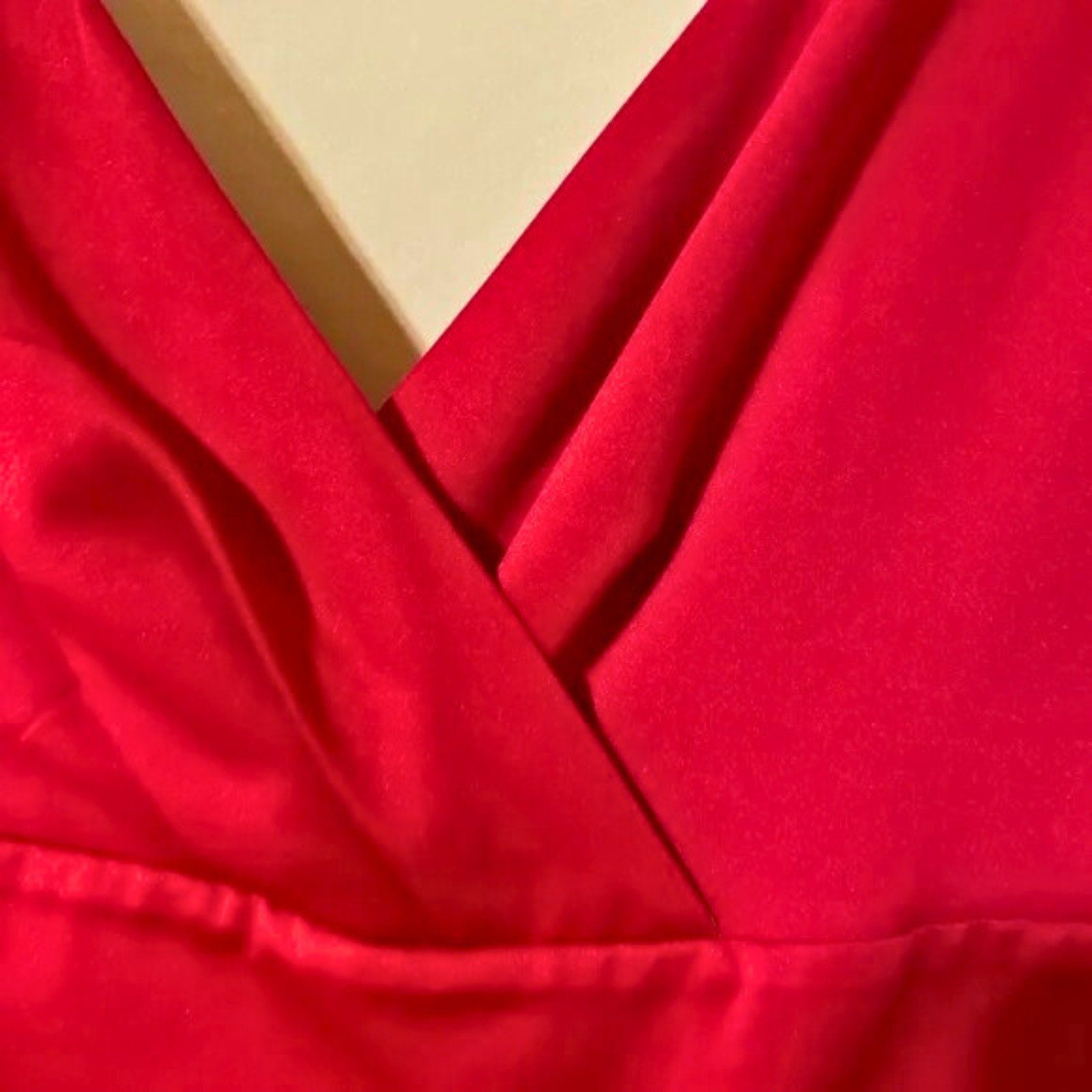 Close-up of red fabric with a yellow box in the background