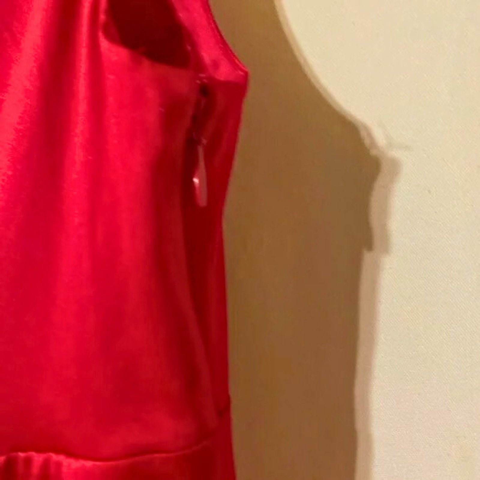 Red sleeveless top on a beige background