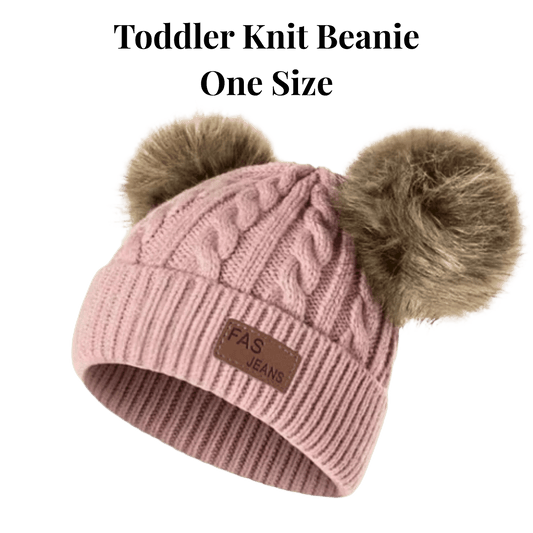 Pink knit beanie with two pom-poms on a green background