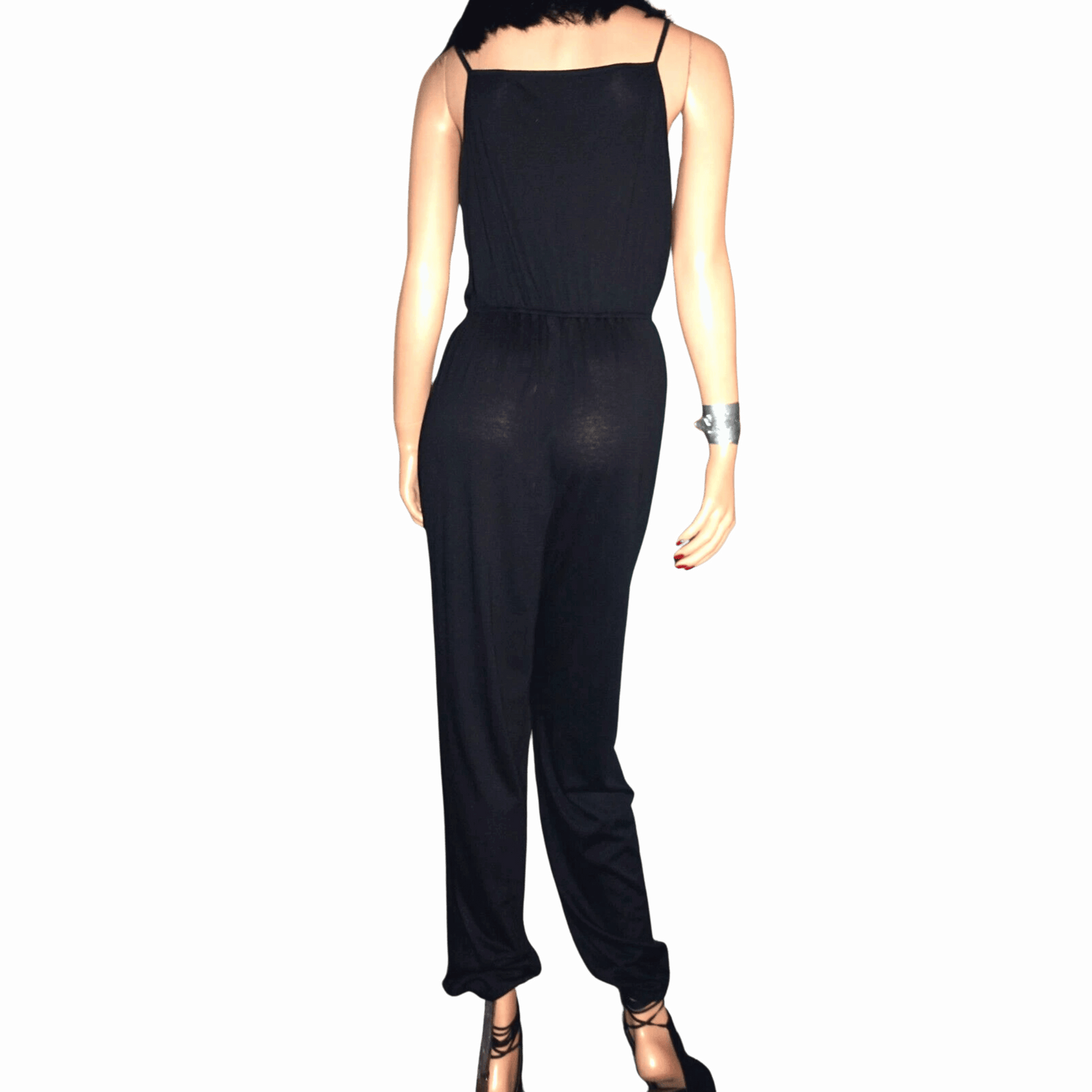 Black jumpsuit on a mannequin against a black background