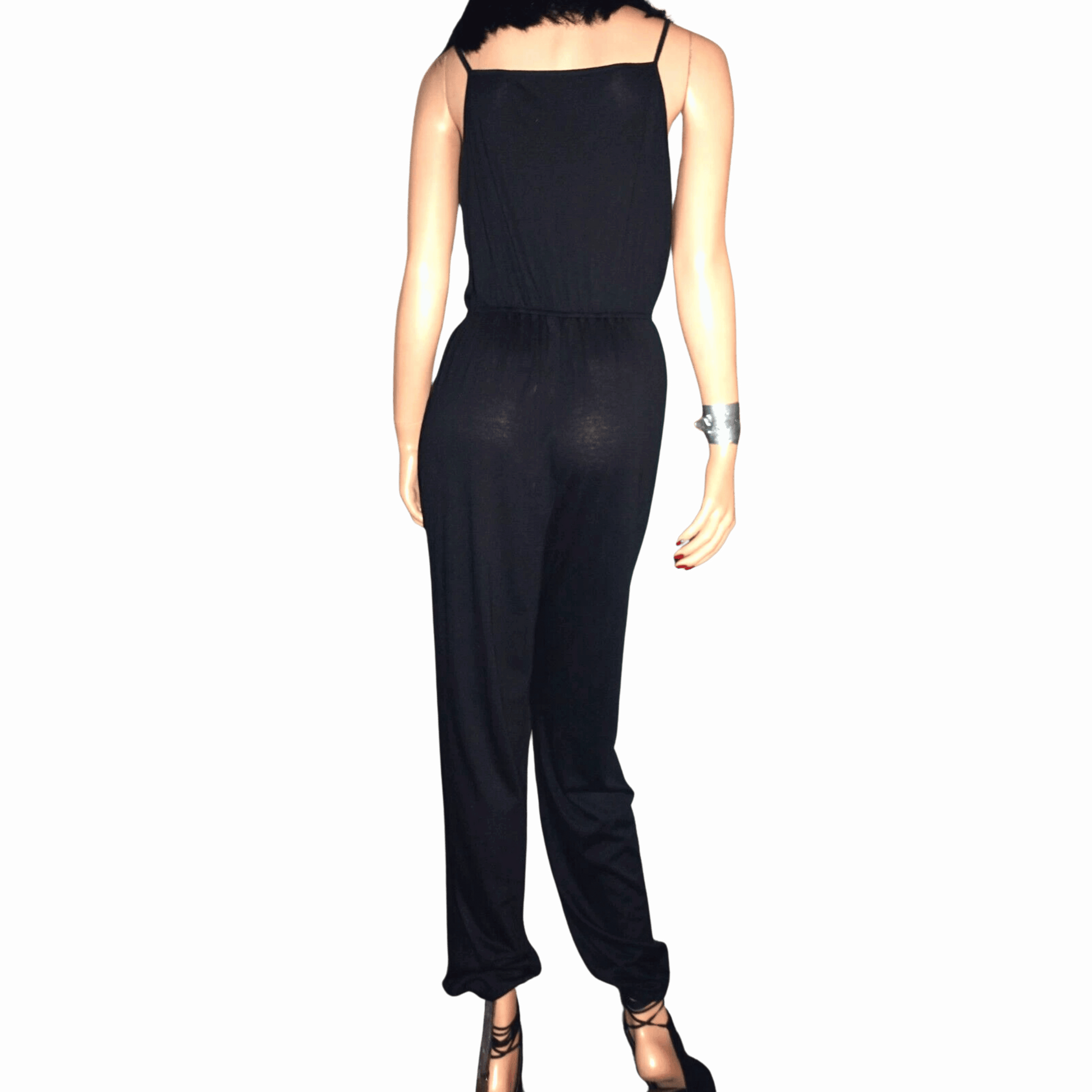 Black jumpsuit on a mannequin against a black background