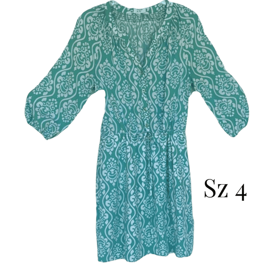 Teal patterned dress with 'Sz 4' label on a green background