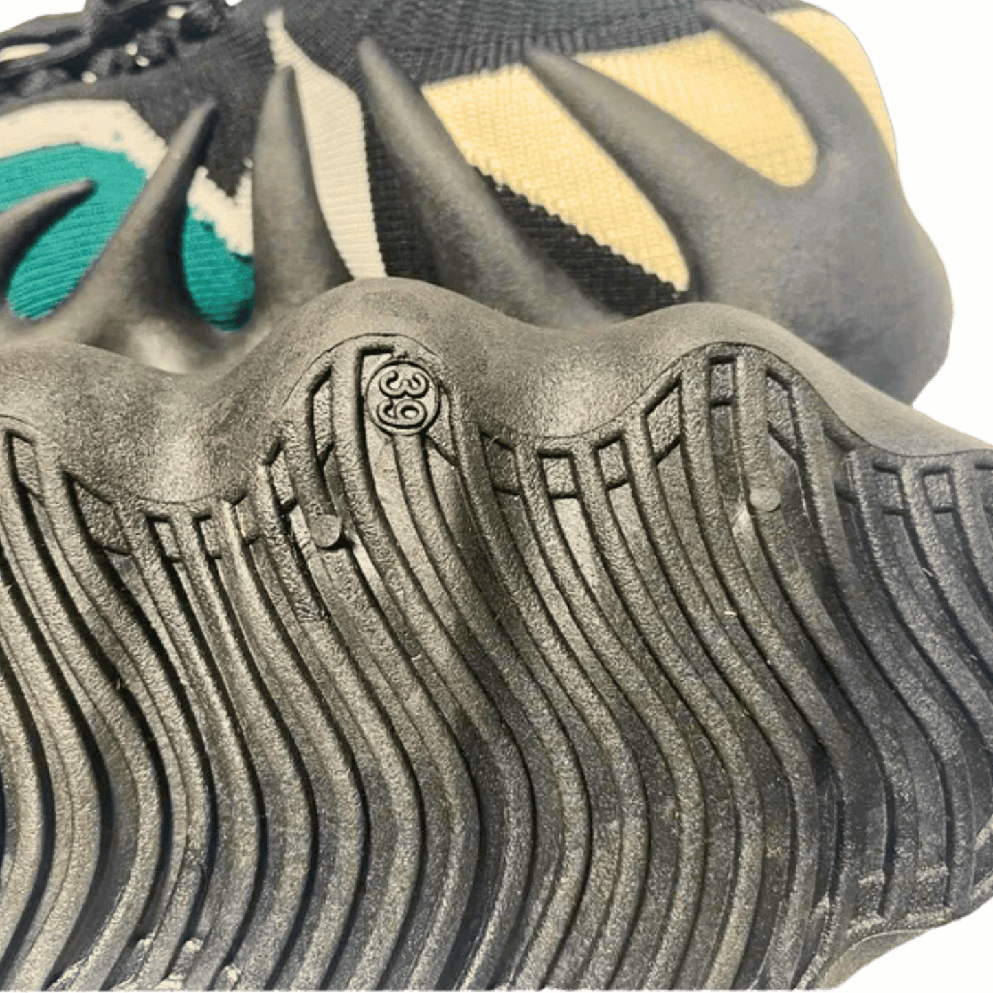 Close-up of a shoe sole with unique tread pattern and brand logo.